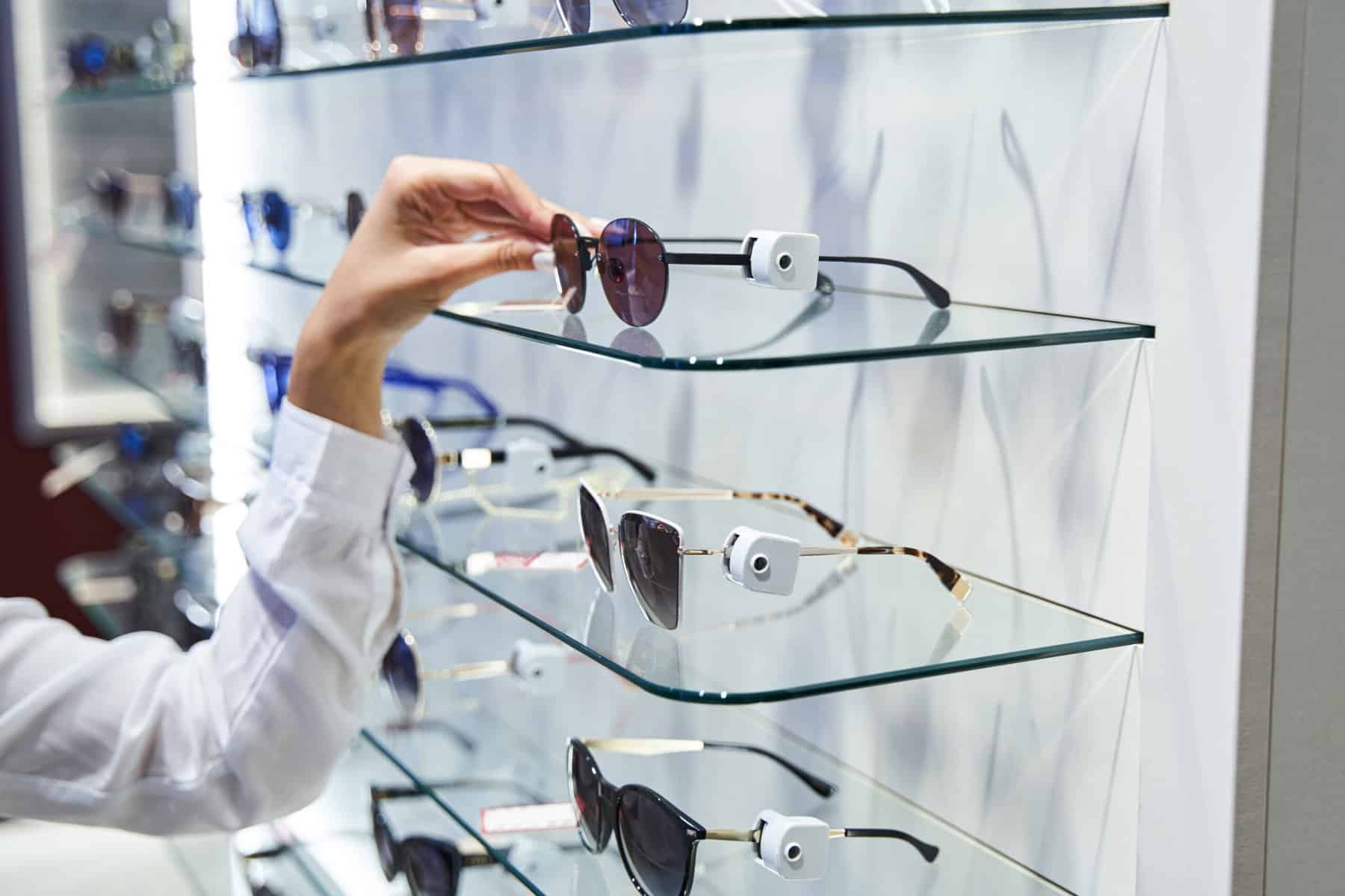 female hand taking sunglasses from glass shelf in 2021 09 03 23 33 14 utc scaled 1